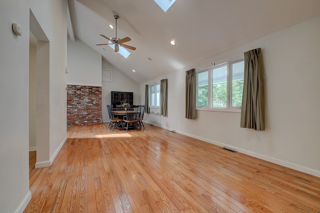 32 Bayberry Road Groton, MA 01450 - Photo 22 of 30 a view of a livingroom with a flat screen tv wooden floor and a window