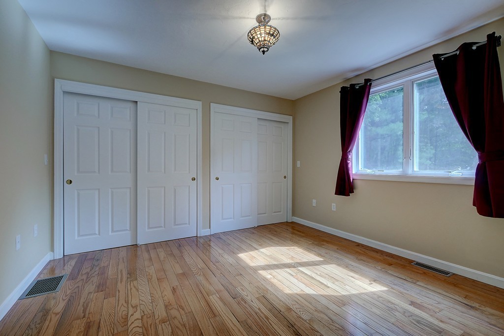 32 Bayberry Road Groton, MA 01450 - Photo 26 of 30 a view of empty room with wooden floor and fan