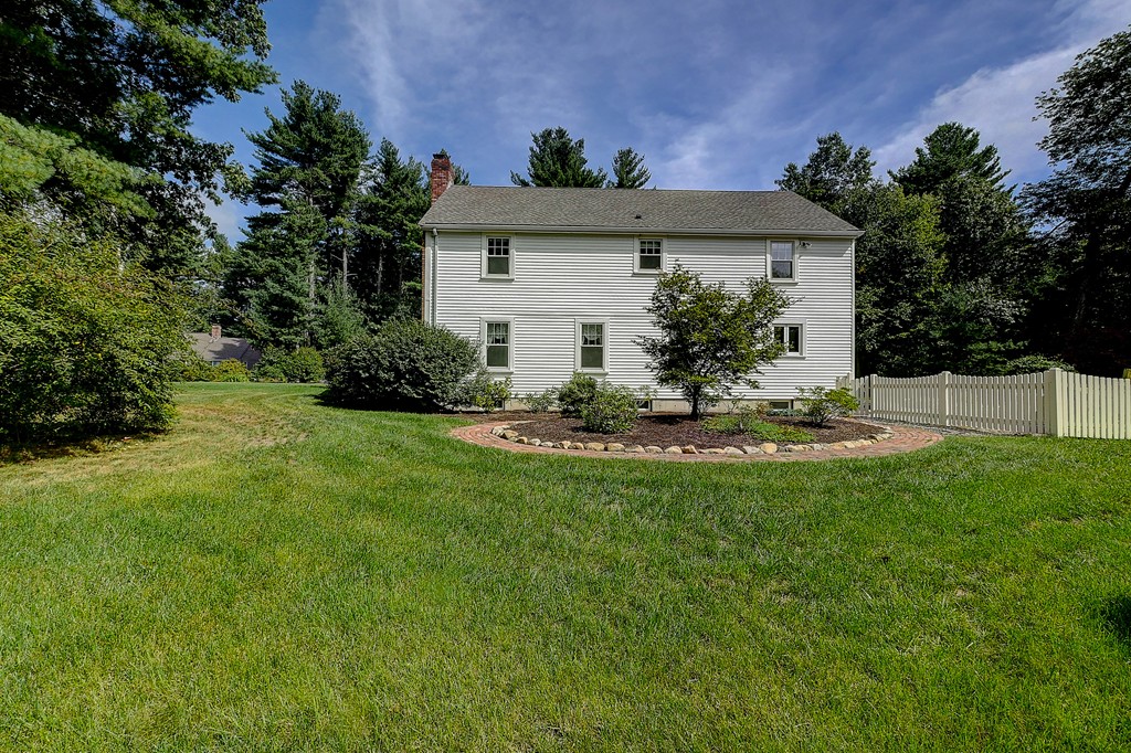 32 Bayberry Road Groton, MA 01450 - Photo 30 of 30 a view of a white house with a yard and potted plants