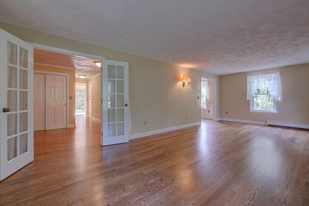 32 Bayberry Road Groton, MA 01450 - Photo 4 of 30 a view of an empty room with wooden floor and a window