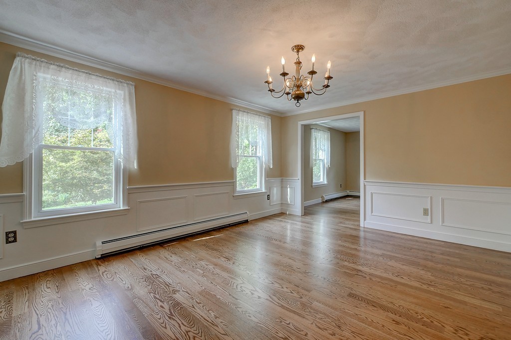32 Bayberry Road Groton, MA 01450 - Photo 5 of 30 a view of an empty room with wooden floor and a window