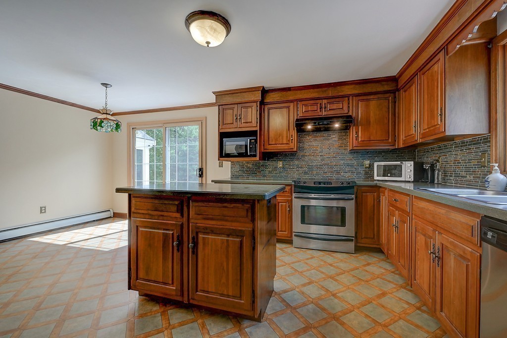 32 Bayberry Road Groton, MA 01450 - Photo 6 of 30 a kitchen with stainless steel appliances granite countertop a stove sink and cabinets