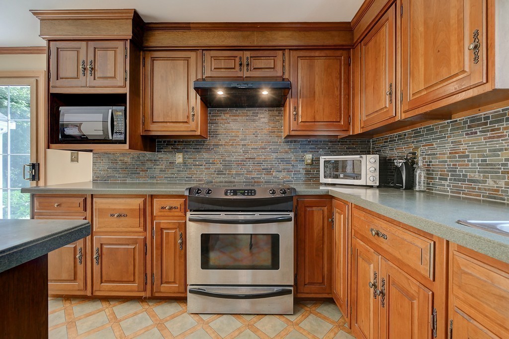 32 Bayberry Road Groton, MA 01450 - Photo 7 of 30 a kitchen with stainless steel appliances granite countertop a stove a sink and a microwave