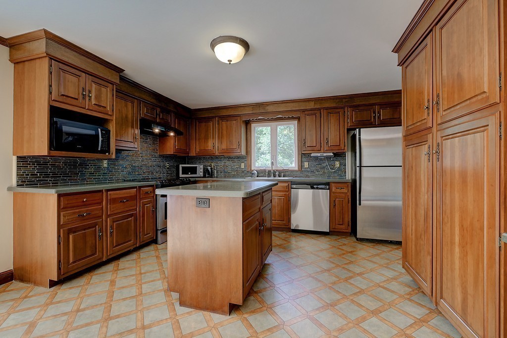 32 Bayberry Road Groton, MA 01450 - Photo 8 of 30 a kitchen with stainless steel appliances granite countertop a stove a sink dishwasher a refrigerator and a microwave oven