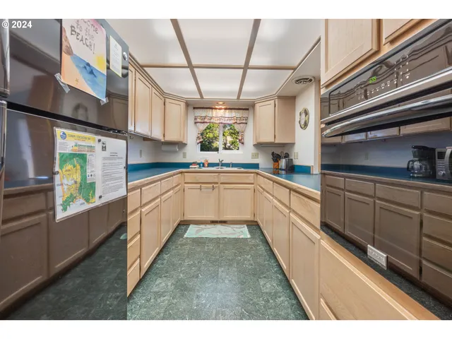 a large kitchen with cabinets and wooden floor