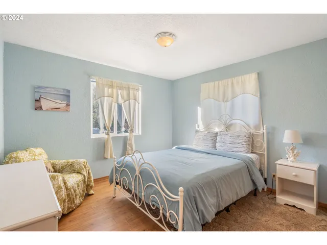 a bedroom with a bed and a lamp