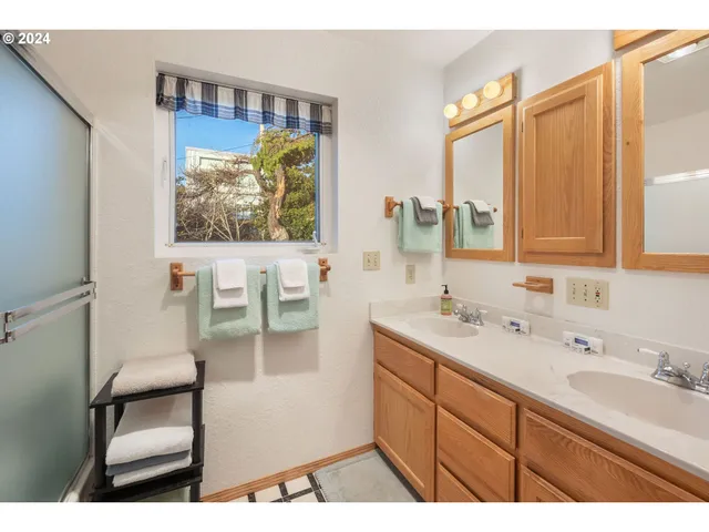a bathroom with a sink a mirror and a painting on the wall