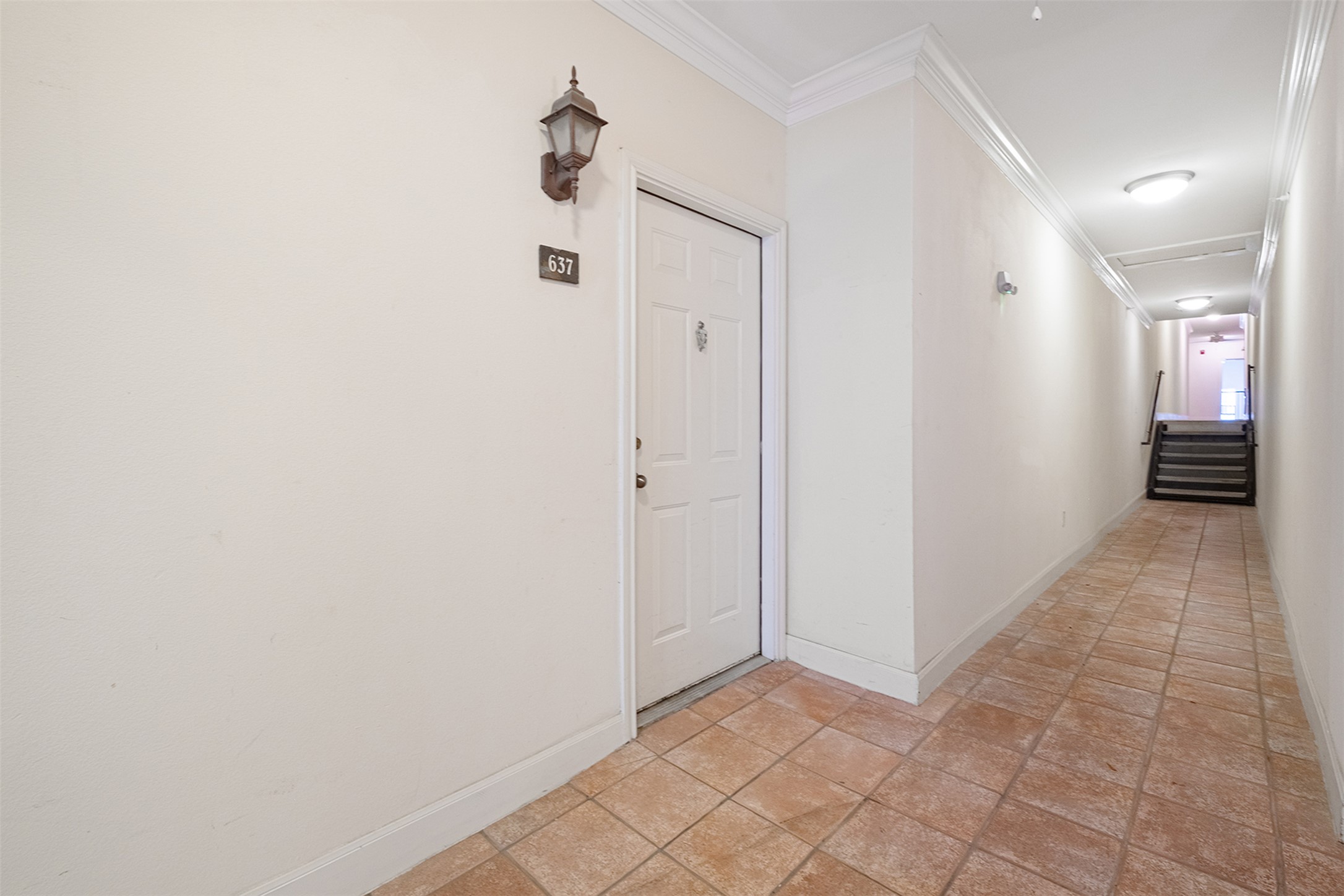 7701 Rialto Boulevard, Unit 637 Austin, TX 78735 - Photo 3 of 25 A welcoming entryway with tiled flooring leads to a private residence, offering a serene corridor.