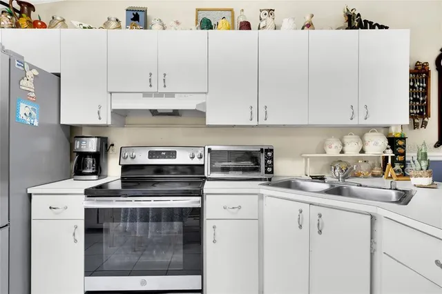 a kitchen with cabinets appliances and a sink