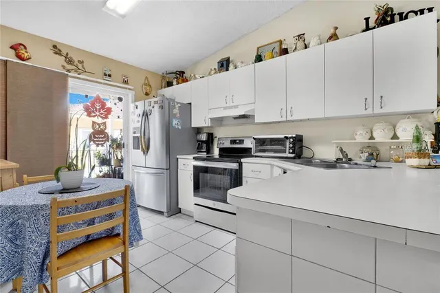 a kitchen with stainless steel appliances a refrigerator sink and cabinets