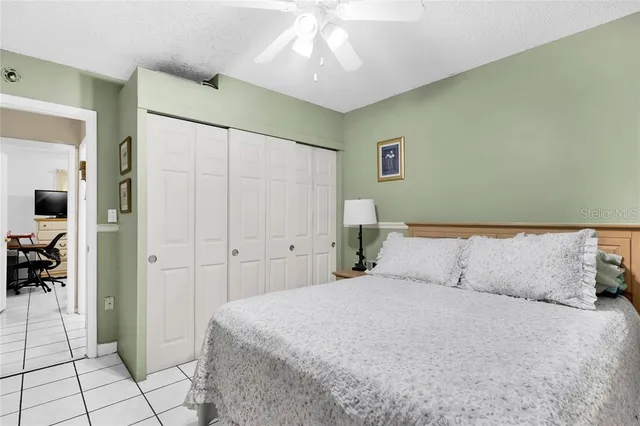 a bedroom with a large bed and a chandelier