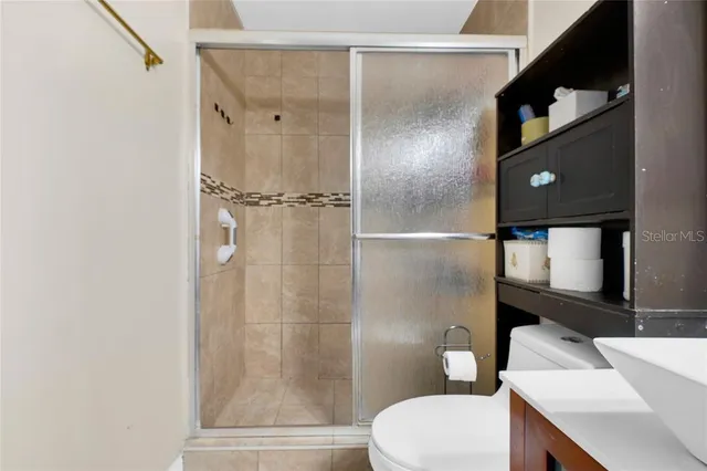 a bathroom with a toilet a sink and shower