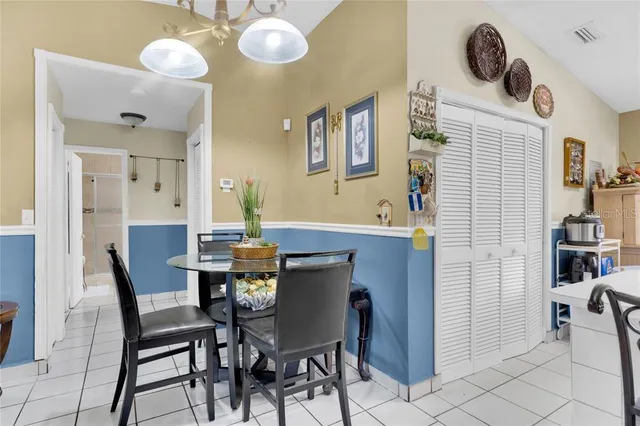 a view of a dining room with furniture and chandelier