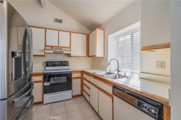 a kitchen with a sink and stainless steel appliances