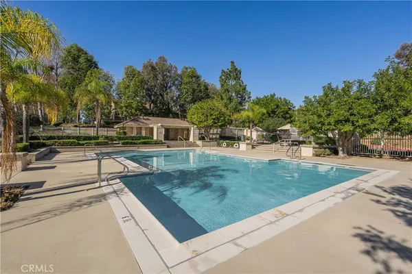 swimming pool view with a garden space