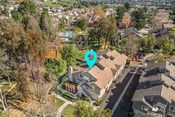 an aerial view of a house with swimming pool and outdoor space