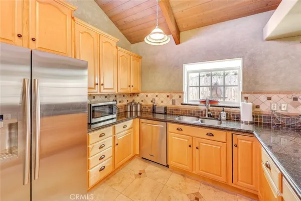 a kitchen with stainless steel appliances granite countertop a stove and a sink