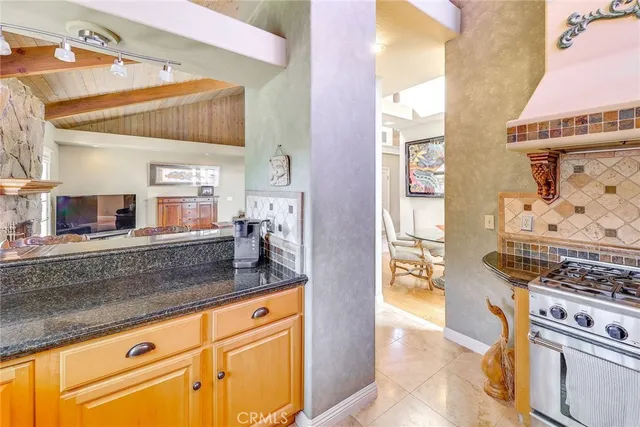 a kitchen with stainless steel appliances granite countertop a sink stove and cabinets