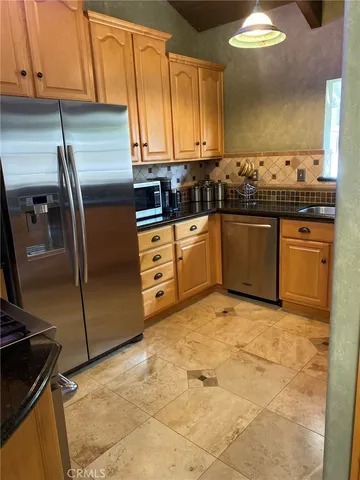 a kitchen with a stove and a refrigerator