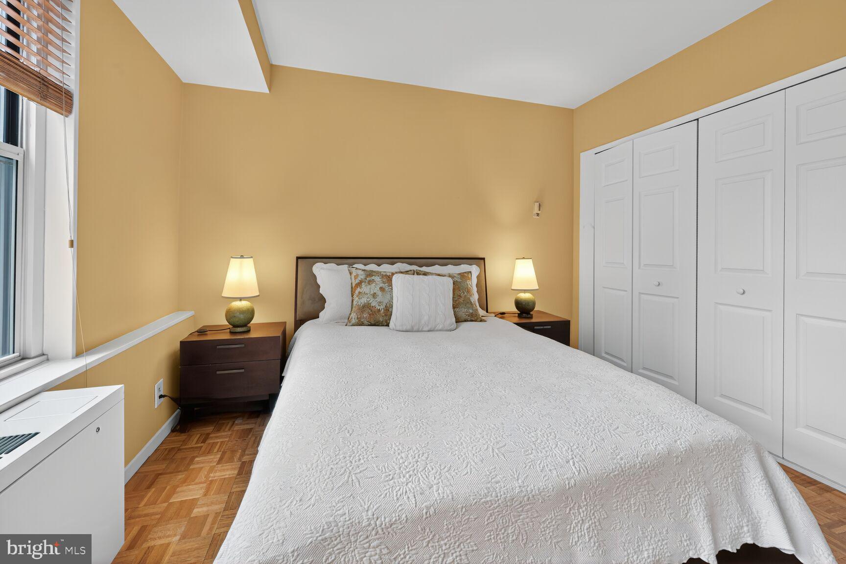 3900 Watson Place Northwest, Unit B1G Washington, DC 20016 - Photo 11 of 16 a bedroom with a bed and lamps