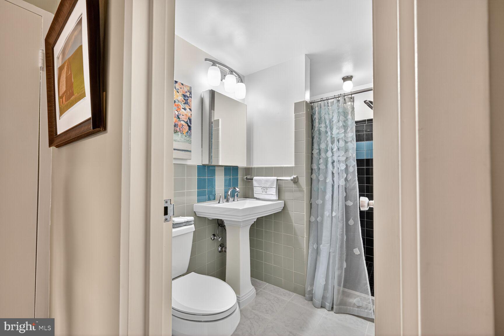 3900 Watson Place Northwest, Unit B1G Washington, DC 20016 - Photo 12 of 16 a bathroom with a sink toilet and shower