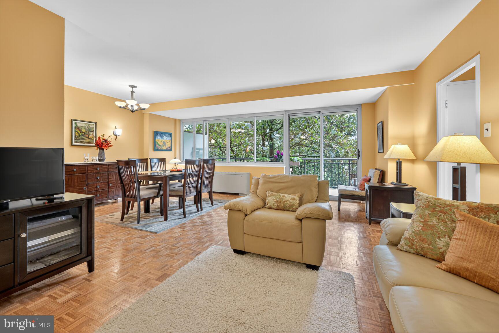 3900 Watson Place Northwest, Unit B1G Washington, DC 20016 - Photo 2 of 16 a living room with furniture and a flat screen tv