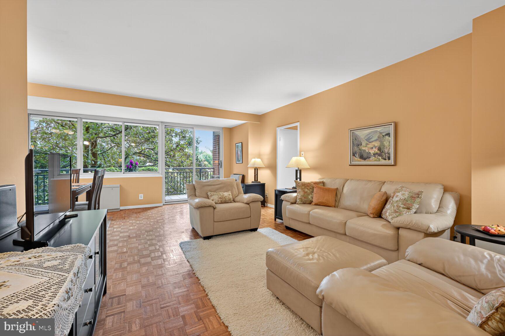 3900 Watson Place Northwest, Unit B1G Washington, DC 20016 - Photo 3 of 16 a living room with furniture and a large window