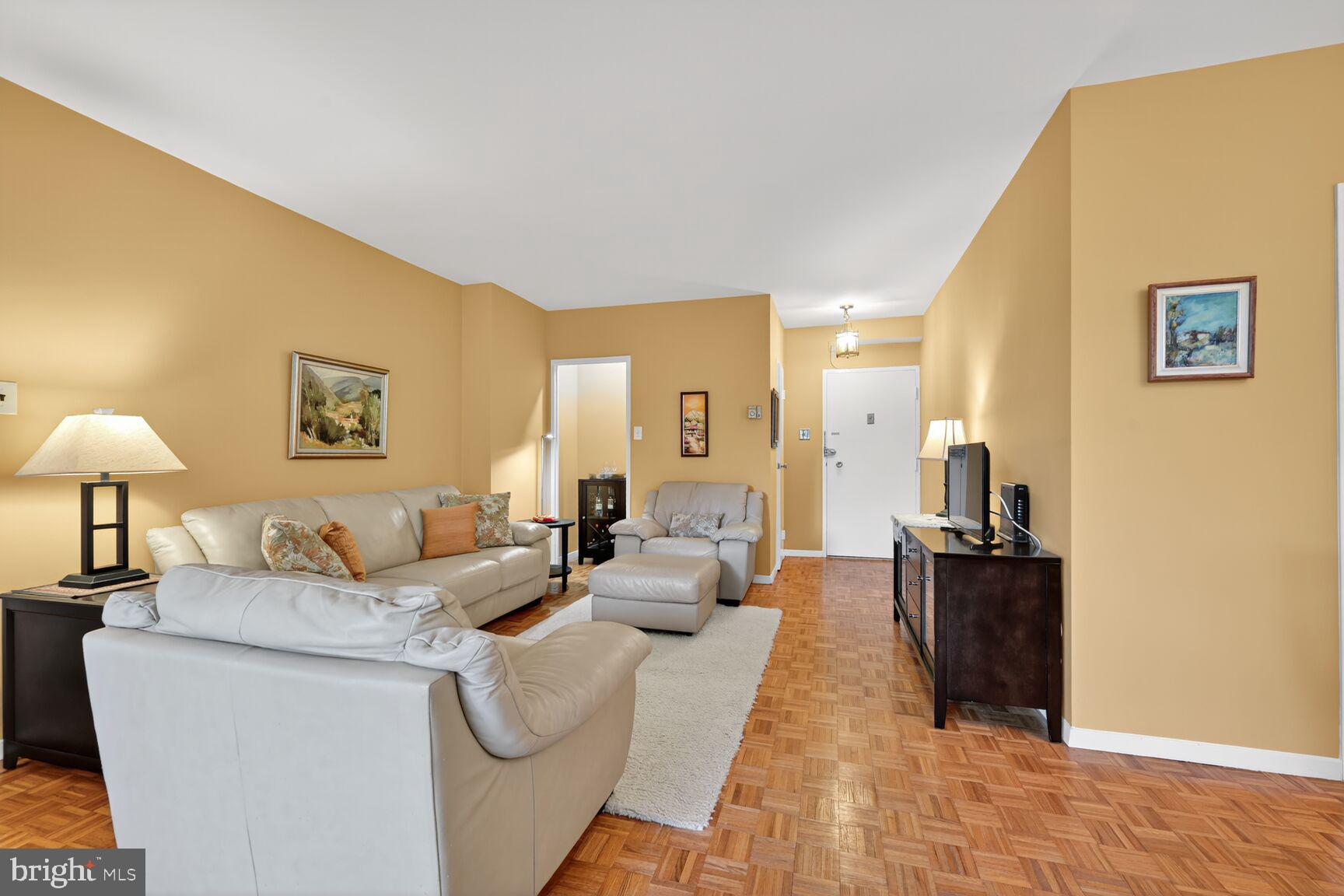 3900 Watson Place Northwest, Unit B1G Washington, DC 20016 - Photo 4 of 16 a living room with furniture and a lamp