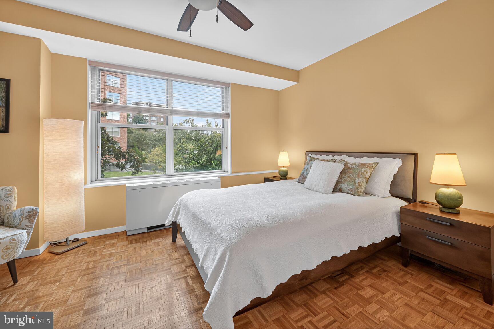 3900 Watson Place Northwest, Unit B1G Washington, DC 20016 - Photo 9 of 16 a bedroom with a large bed and a large window