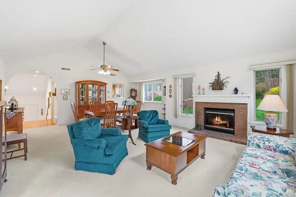 a kitchen with stainless steel appliances granite countertop a stove a sink dishwasher a dining table and chair with wooden floor