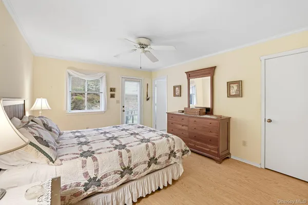 a bedroom with a bed and flat screen tv