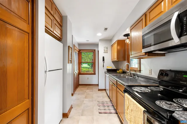 a kitchen with stainless steel appliances granite countertop a stove and a refrigerator