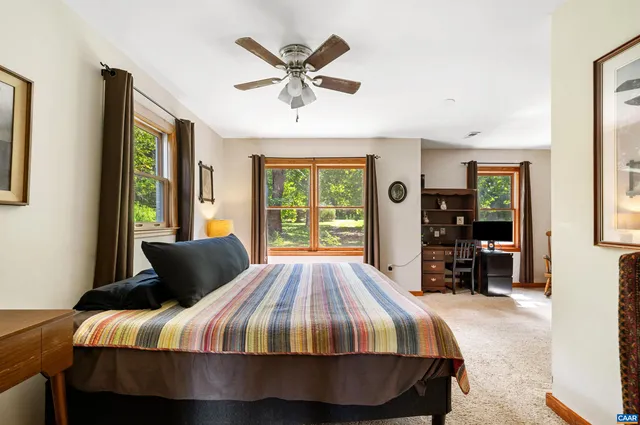 a bedroom with a bed and a large window