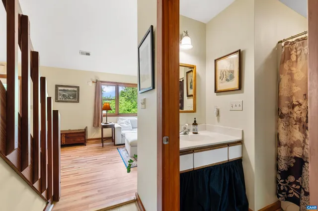 a en suite bathroom with a sink a mirror and a shower