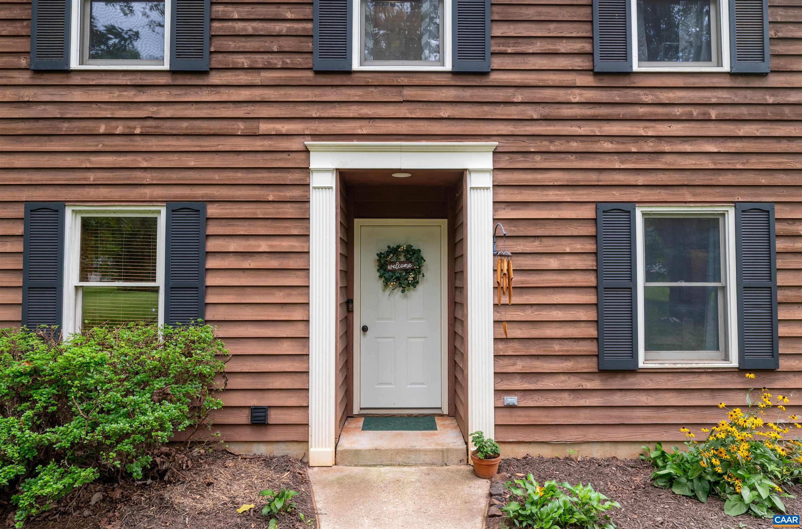 189 Edgehill Way Faber, VA 22938 - Photo 2 of 44 a front view of a house with a garden