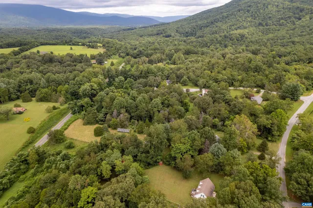 a view of a lake with a mountain and trees in the background