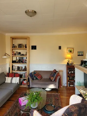 a living room with furniture and flower pot