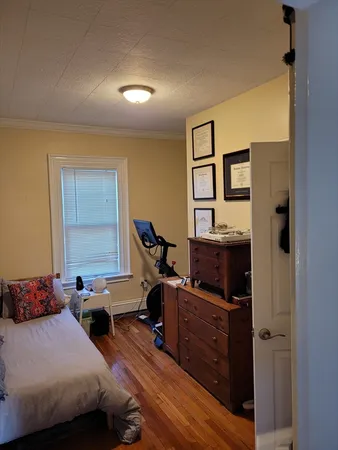 a bedroom with furniture and a window