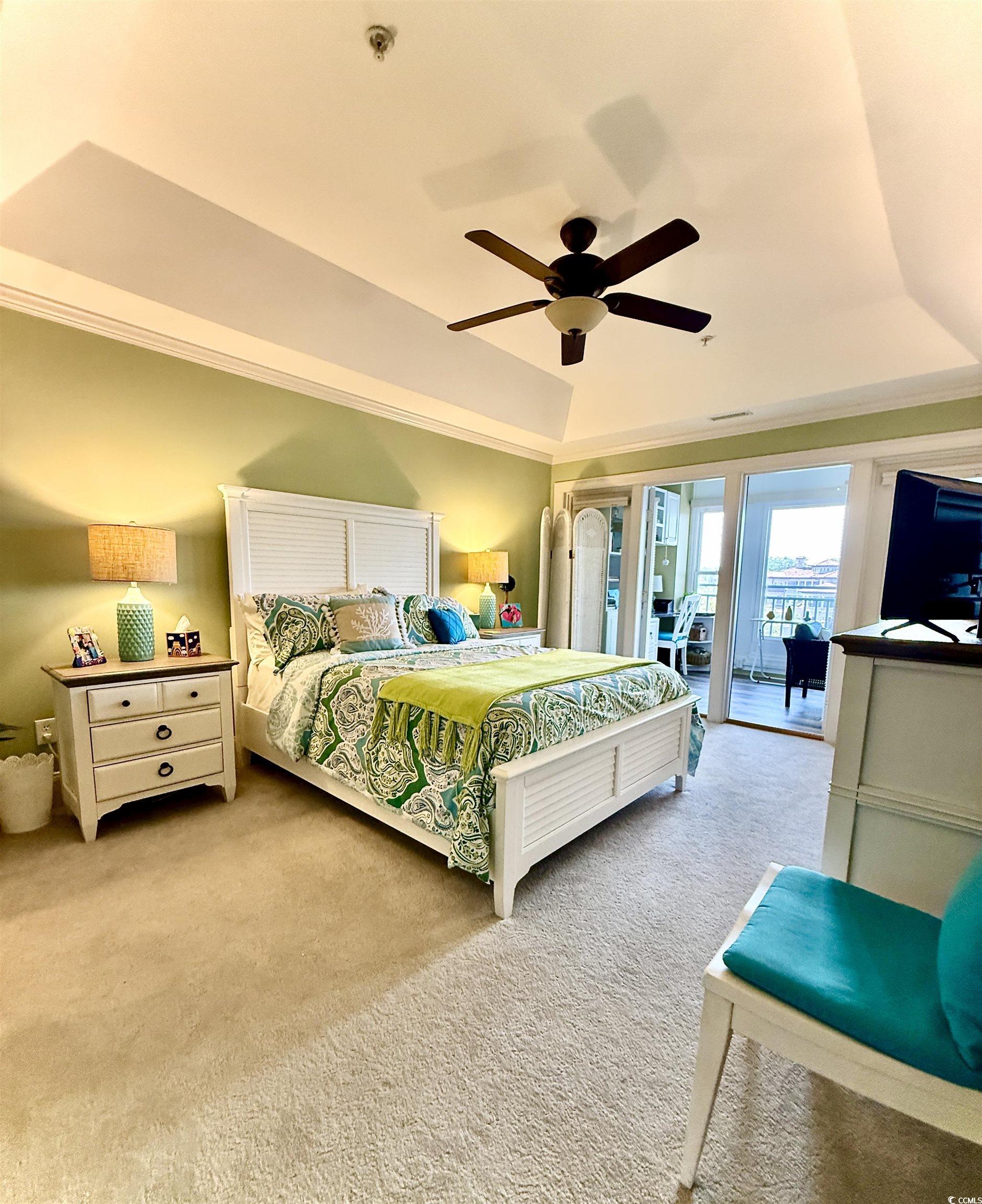 1330 Villa Marbella Court, Unit 303 Myrtle Beach, SC 29572 - Photo 15 of 40 Bedroom with a tray ceiling, access to exterior, light carpet, crown molding, and ceiling fan