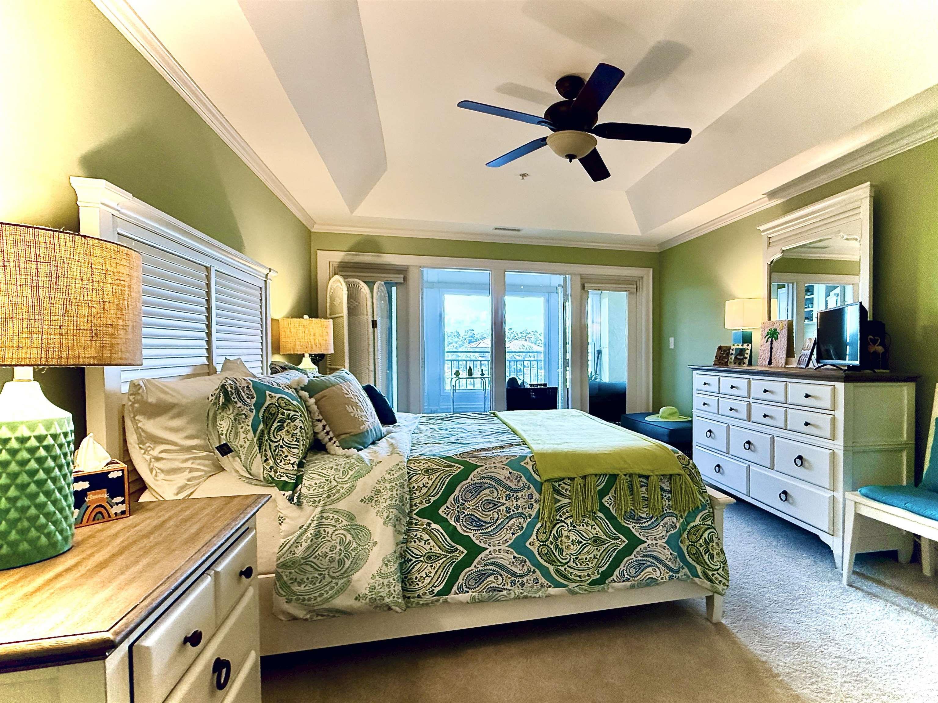 1330 Villa Marbella Court, Unit 303 Myrtle Beach, SC 29572 - Photo 16 of 40 Carpeted bedroom featuring ornamental molding, access to outside, a tray ceiling, and ceiling fan