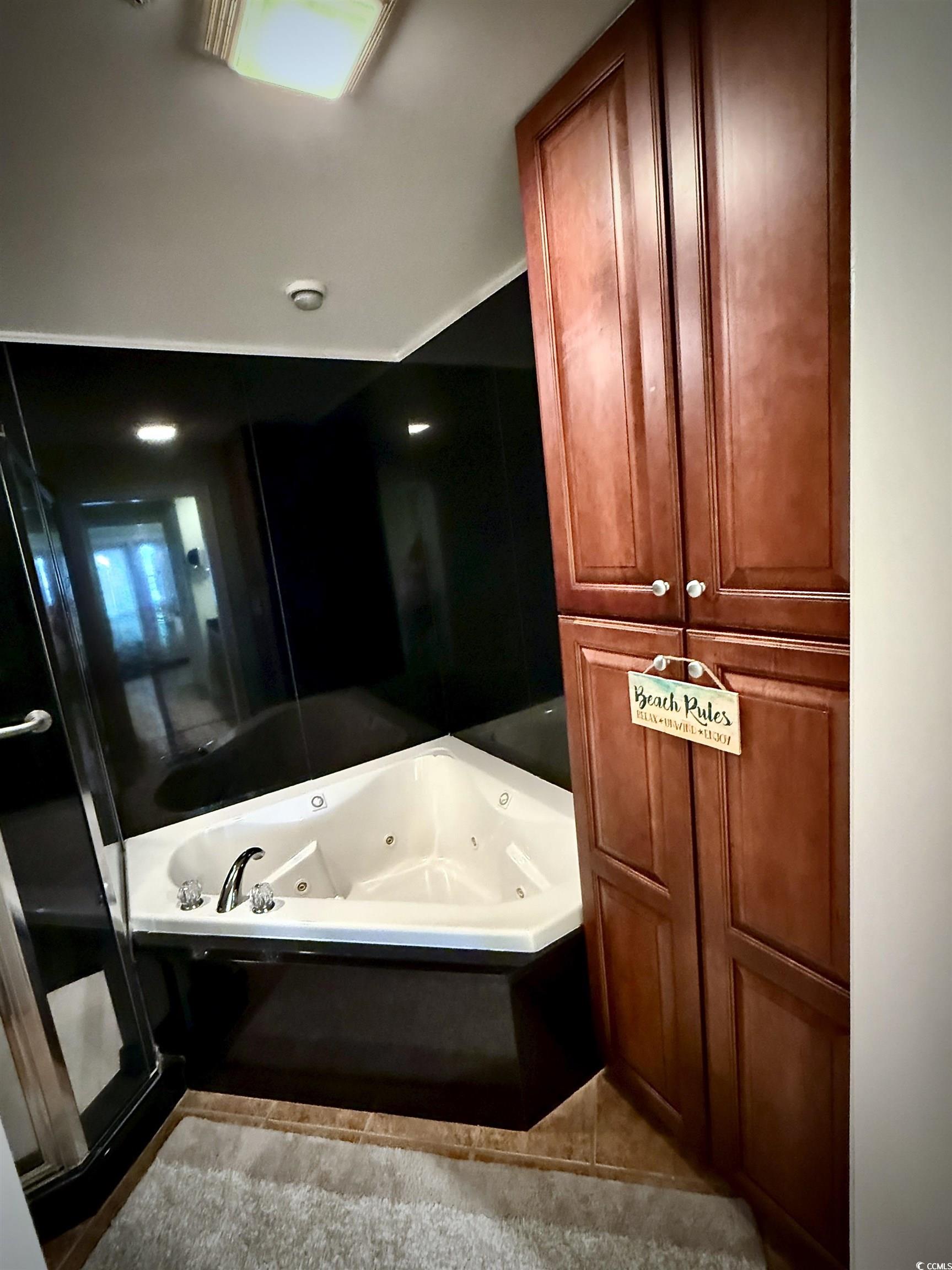 1330 Villa Marbella Court, Unit 303 Myrtle Beach, SC 29572 - Photo 21 of 40 Full bathroom with a jetted tub, tile patterned flooring, and a shower stall