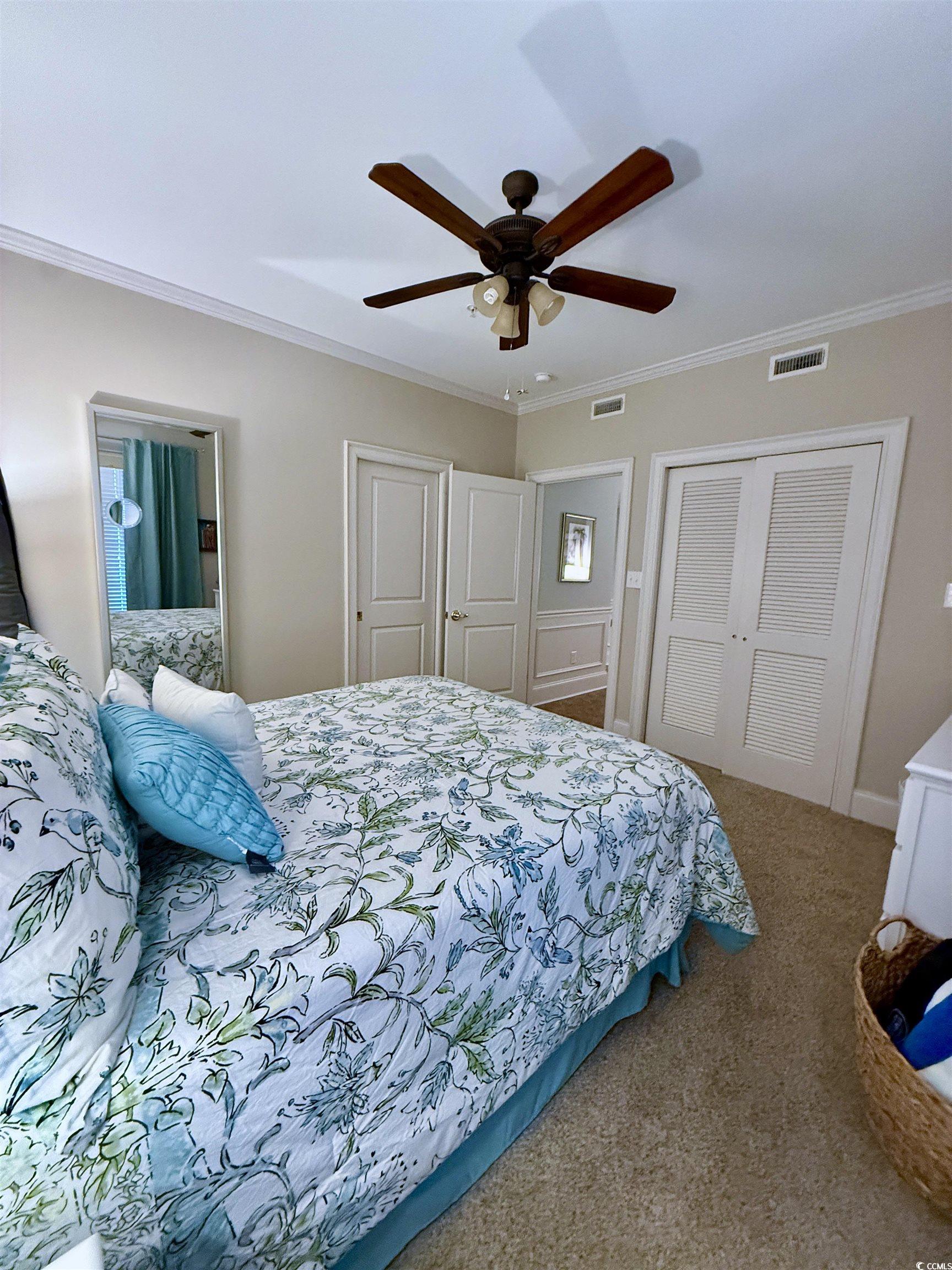 1330 Villa Marbella Court, Unit 303 Myrtle Beach, SC 29572 - Photo 23 of 40 Bedroom with crown molding, carpet, and ceiling fan