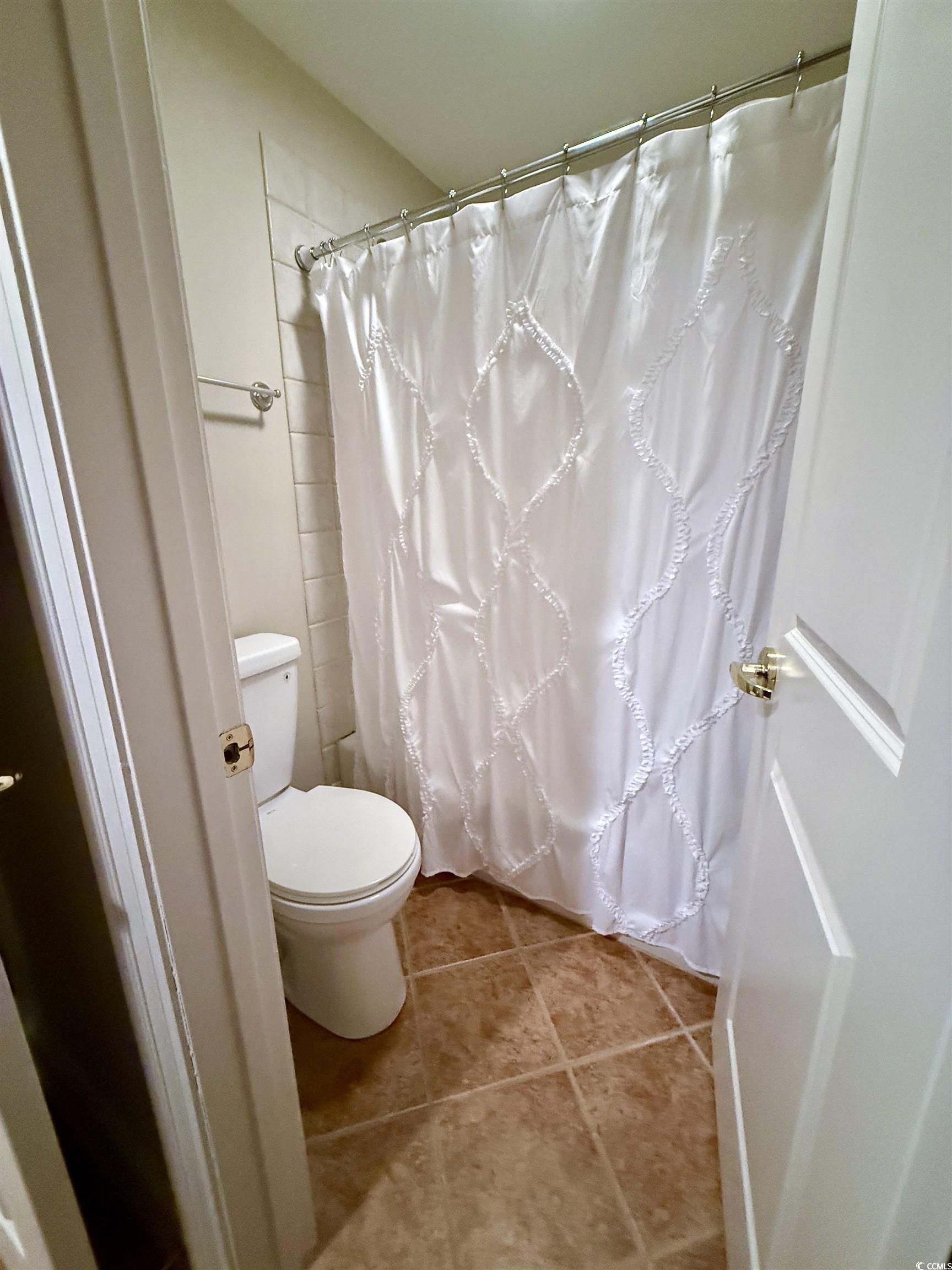 1330 Villa Marbella Court, Unit 303 Myrtle Beach, SC 29572 - Photo 27 of 40 Full bath featuring tile patterned floors and a shower with curtain