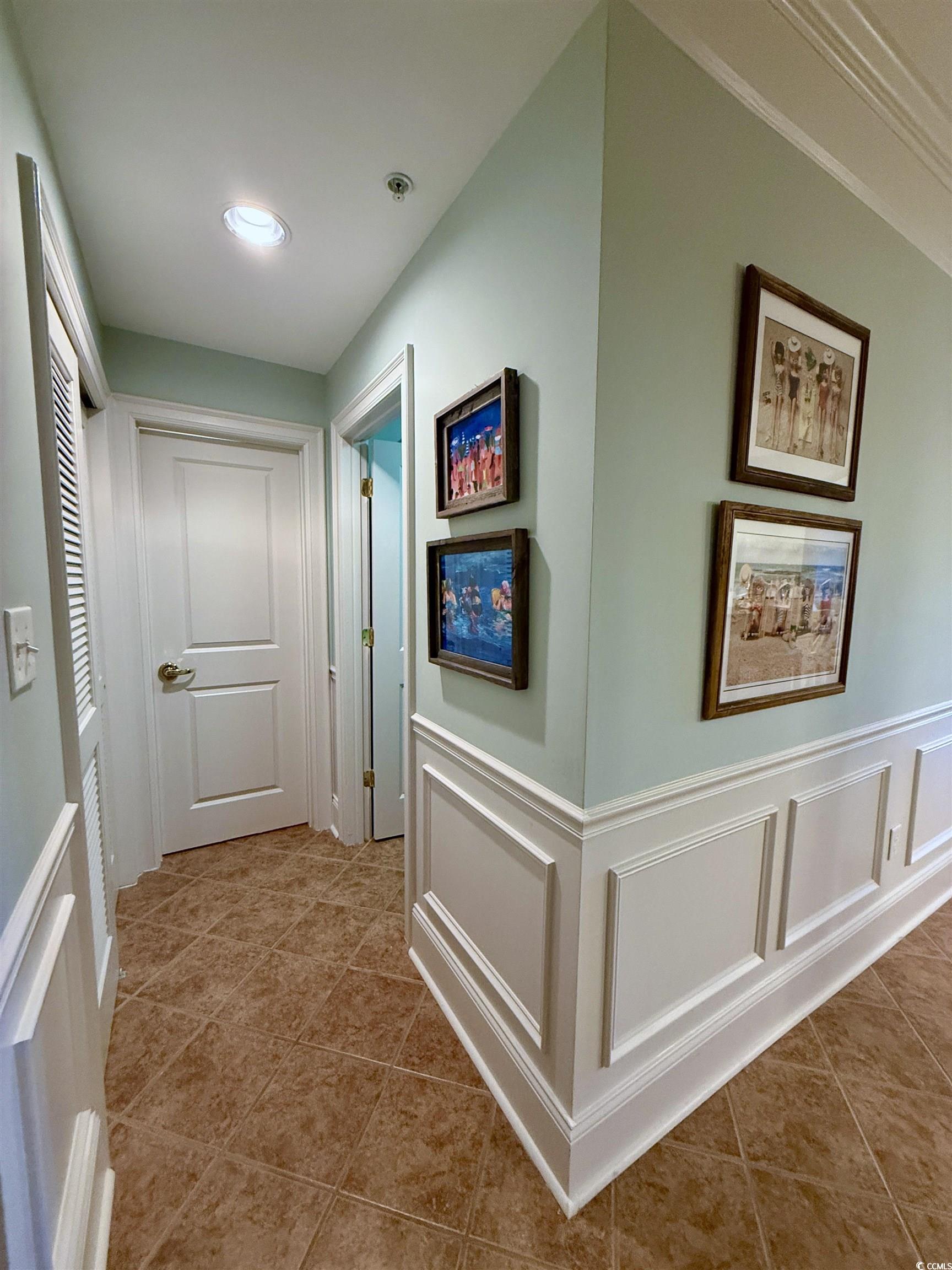 1330 Villa Marbella Court, Unit 303 Myrtle Beach, SC 29572 - Photo 28 of 40 Corridor with a decorative wall, tile patterned flooring, and wainscoting