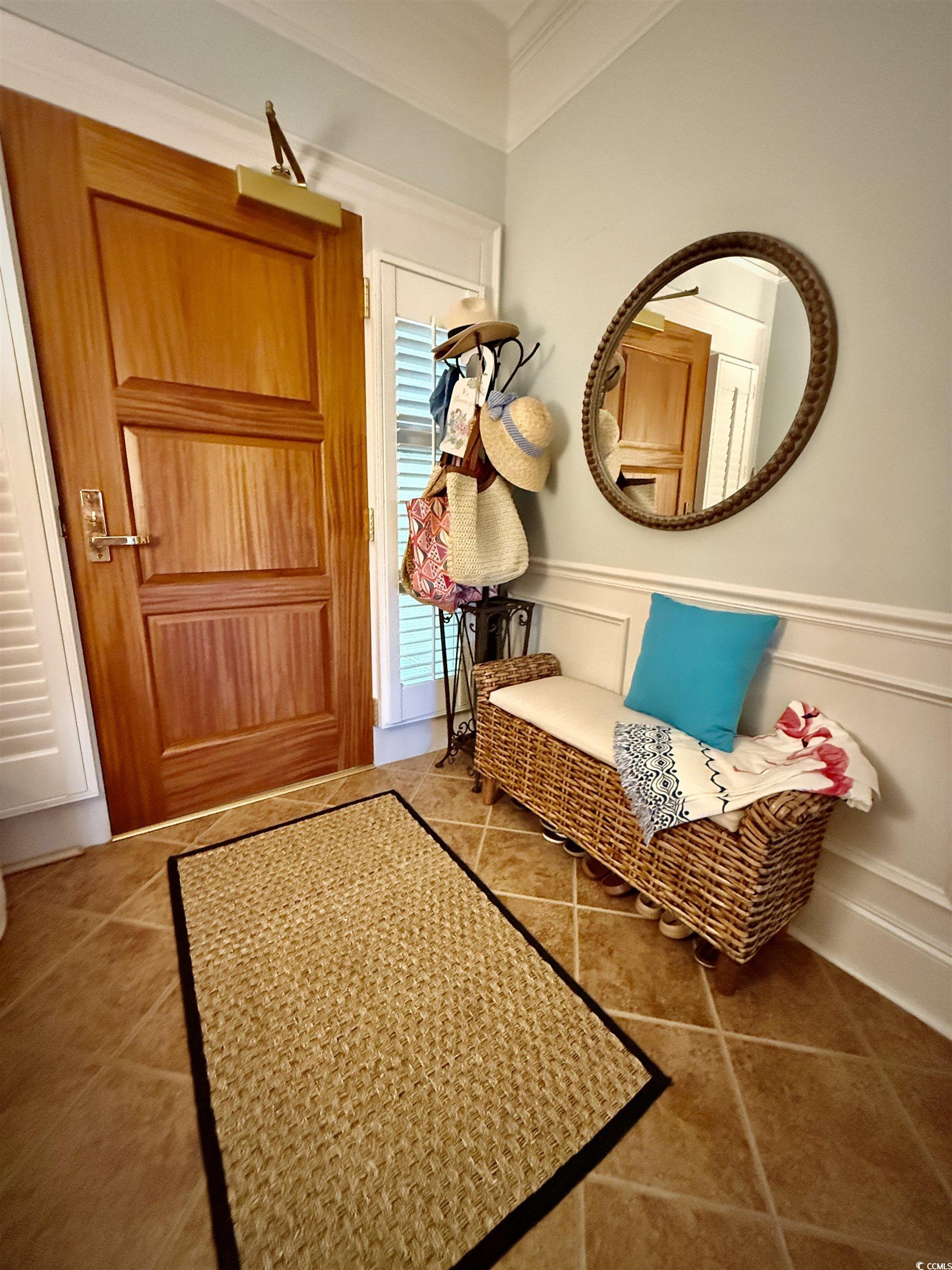 1330 Villa Marbella Court, Unit 303 Myrtle Beach, SC 29572 - Photo 33 of 40 Mudroom with a decorative wall, a wainscoted wall, tile patterned floors, and ornamental molding