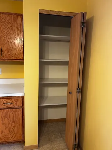 a view of walk in closet with empty racks