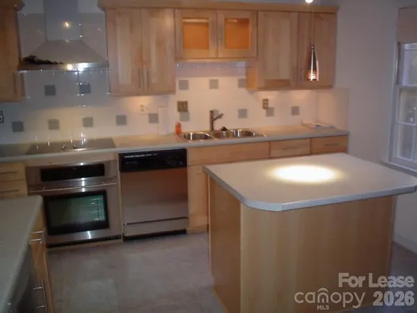 a kitchen with a sink cabinets and appliances