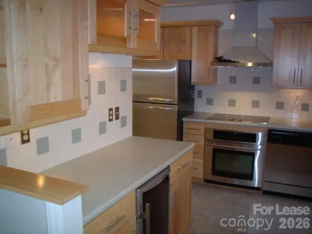 a kitchen with kitchen island a stove a sink and a refrigerator