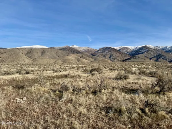 a view of a large mountain with mountains in the background