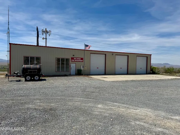 a view of garage with a car parked in it